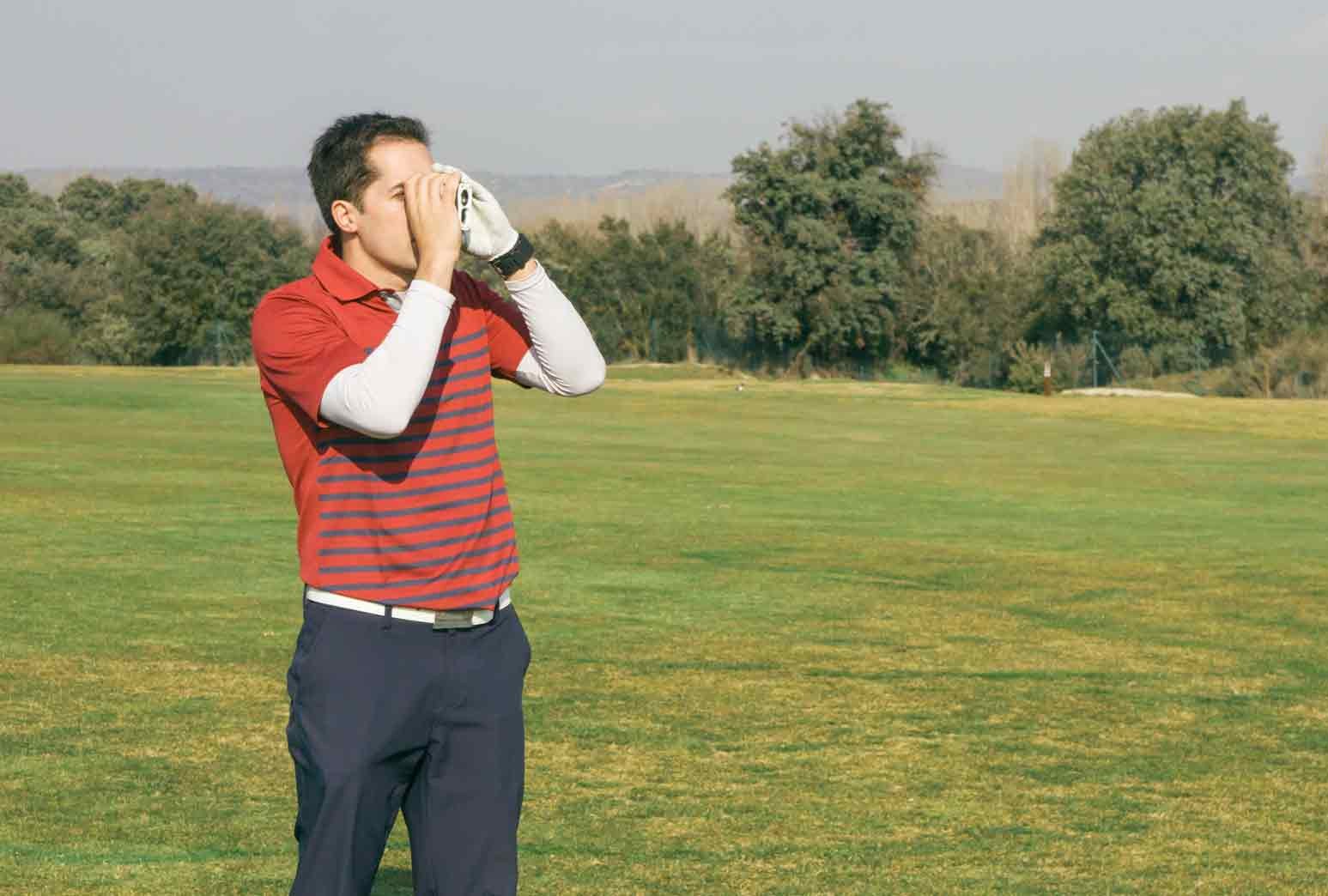 Golfer using golf technology and GPS equipment on the course